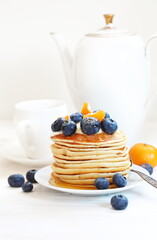 Pancakes with blueberries on a white background