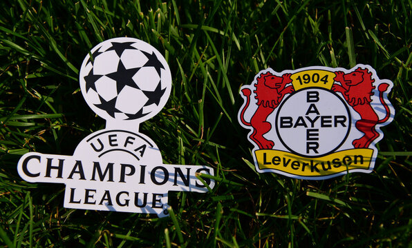 September 6, 2019 Istanbul, Turkey. The emblem of the German football club Bayer Leverkusen next to the logo of the Champions League on the green grass of the football field.