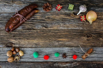 Obraz na płótnie Canvas Traditional table top view with home made sausages and Christmas decor