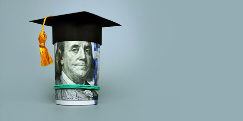 Fototapeta Loan or savings for college. Graduation cap and roll of cash. obraz