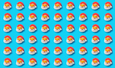Fototapeta na wymiar pattern of cute Santa Claus candies on a blue background