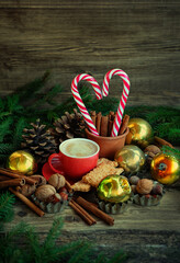 Coffee cup, cookies, candy cane, Christmas decor on rustic background. Christmas and New Year Holiday concept. festive winter season. vintage style