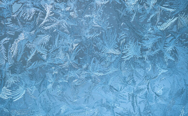  Frosty pattern on the window pane. Winter background