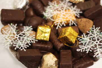 chocolate and Christmas decorations on white background