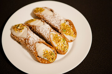 Cannoli are Italian pastries consisting of tube-shaped shells of fried pastry dough, filled with a sweet, creamy filling usually containing ricotta—a staple of Sicilian cuisine. Palermo, Sicily, Italy