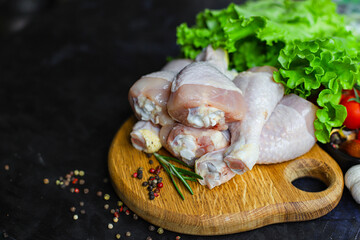 Obraz na płótnie Canvas raw chicken drumsticks meat for cooking on the table healthy meal snack top view copy space for text food background rustic 