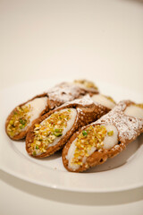 Cannoli are Italian pastries consisting of tube-shaped shells of fried pastry dough, filled with a sweet, creamy filling usually containing ricotta—a staple of Sicilian cuisine. Palermo, Sicily, Italy