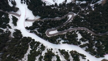 Drone aerial top down of windy Winter Roads in Italian Alps IT ALP 0160 D GR