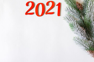 Happy New year 2021. Wooden Christmas or new year decorations on Christmas tree branches. Christmas background with wooden numbers 2021