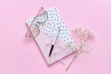 Notebook with pen on color background