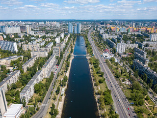 Aerial drone view. Residential buildings on the bank of the canal on a sunny day in Kiev.