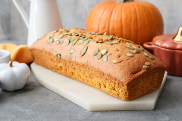 Tasty pumpkin pie on grunge background