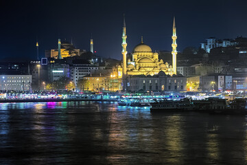 Fototapeta na wymiar Evening view of Yeni Mosque, Hagia Sophia, Eminonu pier and Galata Bridge in Istanbul, Turkey