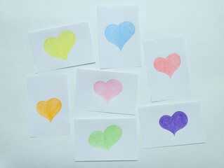 multicolored hearts drawn with pencils on notebook sheets