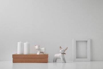 Porcelain figurine of a deer and a bull and New Year's, festive decor. Copy space, mock up.