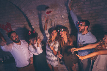 Friends counting down seconds till midnight at New Year's party