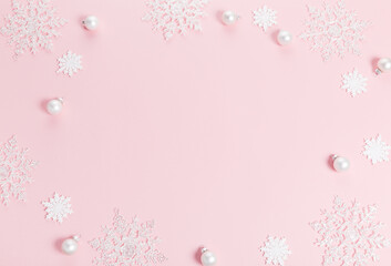 White Christmas holiday composition. Festive creative white pattern, xmas decor holiday ball with snowflakes on pink background.
