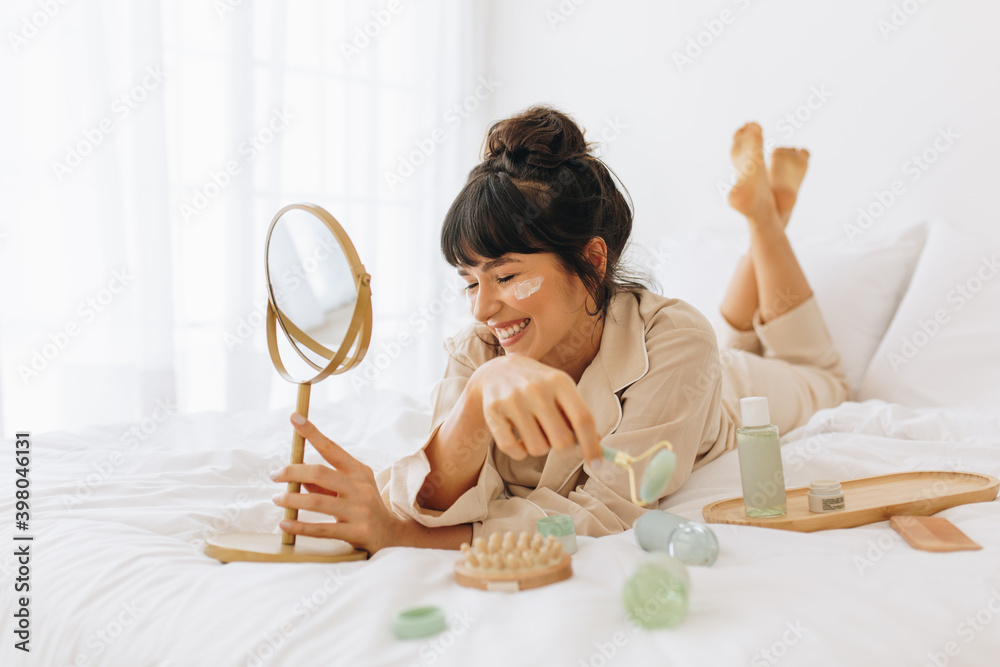 Wall mural woman enjoying skin care activity at home