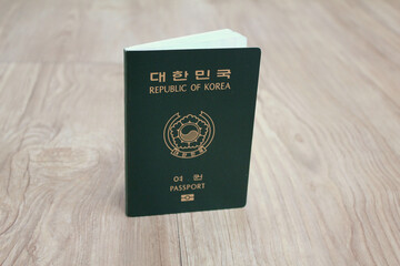 Republic of Korea passport on wooden texture