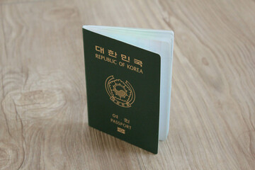 Republic of Korea passport on wooden texture