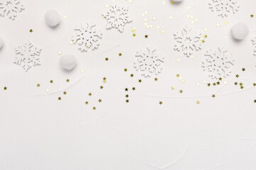 Christmas pattern made of snowflakes and golden stars on white background. Winter holiday concept. Flat lay top view with place for your text
