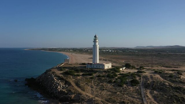 Aerial panoramic drone views of Cape of Trafalgar lighthouse in the Andalusian province of Cadiz, in south Spain at the Atlantic Ocean