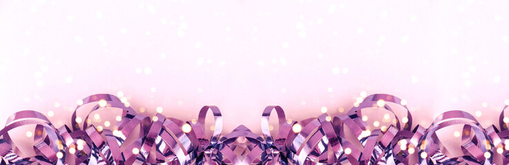 Banner with shiny violet ribbons, lights on a pink background. Christmas background. Festive concept.