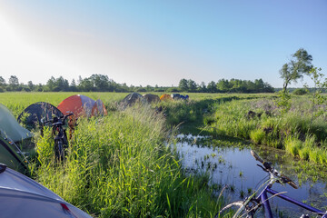 Camping tents in the wetlands. Tourist camp in the swamp.