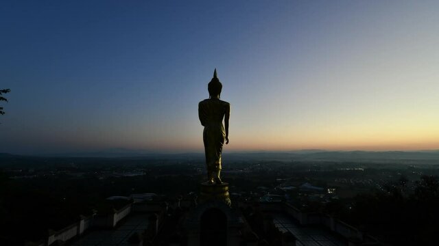 Time lapse of Big golden buddha statue standing in Wat Phra That Kao Noi on morning at Nan province Thailand,