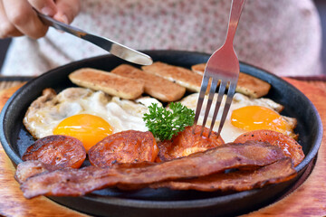 Middle view, Hot pan breakfast set with crispy bacon, tomato, fried egg and bread.