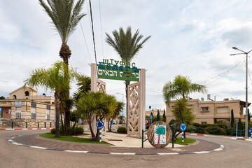 Obraz premium Square with a monument and an inscription in Hebrew and Circassian - Welcome, at the entrance to the Circassian - Adyghe village Kfar Kama, located near the Nazareth in the Galilee, in northern Israel