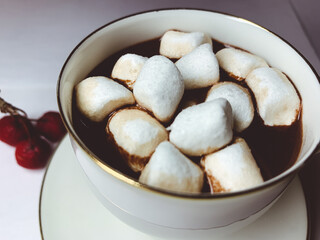 Chocolate with marshmallows in the cup, white background