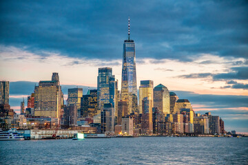 Sunset view of Downtown Manhattan skyline from ferry boat