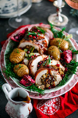 Prosciutto wrapped turkey roulade with pomergranate sauce. .style rustic.
