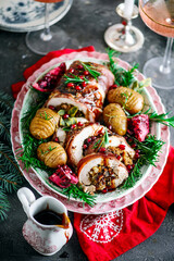 Prosciutto wrapped turkey roulade with pomergranate sauce. .style rustic.