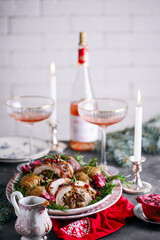 Prosciutto wrapped turkey roulade with pomergranate sauce. .style rustic.