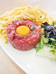 Tasty Steak tartare (Raw beef) - classic steak tartare on white plate