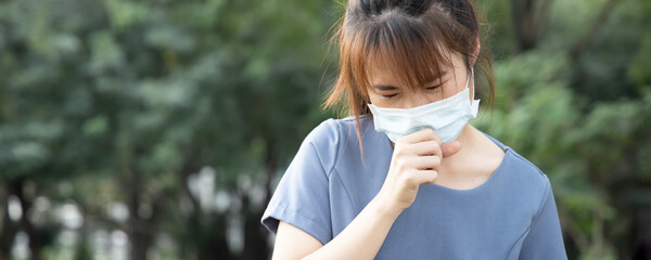Banner of sick coughing asian woman wearing face mask in outdoor park, concept of coronavirus symptomatic infection, social distancing, new normal lifestyle of pre coronavirus cure, COVID-19 vaccine
