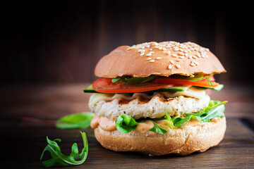 Big sandwich - hamburger burger with turkey meat,  tomato,  cucumber and lettuce.
