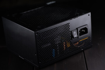 Power supply from a computer on a wooden background