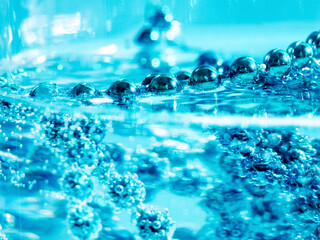 blue beads in water with bubbles, Christmas card, abstraction