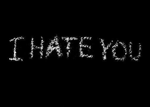 Writing write word "I HATE YOU" on the black background.  