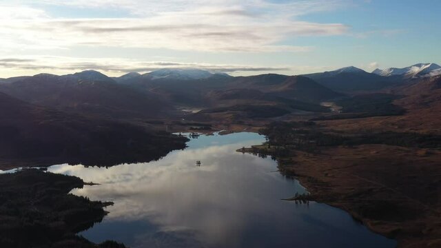 aerial drone view of the loch tulla and bridge of orchy area in the argyll region of the highlands of scotland during autumn on a clear bright day showing calm waters on the inland loch