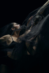 Passion. Graceful classic ballet dancers isolated on black studio background. Couple in...