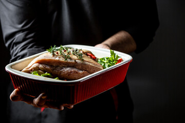 pork knuckle meat with ingredients, preparation in marinade with beer. Oktovber recipe for festival. banner, menu recipe. a chef hands preparing bavarian pork knuckle