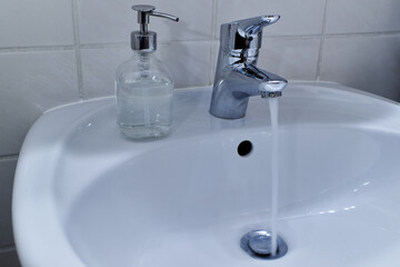 Running water tap. Running faucet.