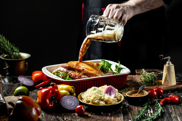 Close up of a chef hands preparing pork knuckle. Cook preparing delicious pork knuckle with the...