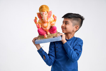 Indian little boy with lord ganesha , Celebrating Ganesh Festival