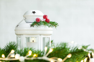 Fototapeta na wymiar Christmas decoration lantern with burning candle and cristmas balls on light festive background