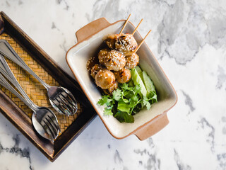 Toasted meatballs topped with spicy sauce